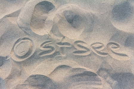 Baltic Sea painted in letters on sandy beach in Germanの写真素材