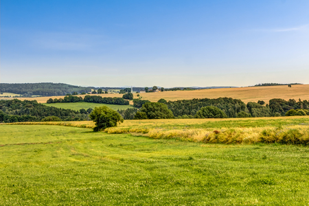 Agricultural area in summer with meadows and fieldsの写真素材