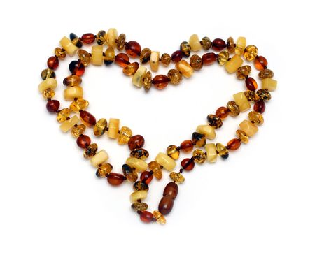 heart shape from amber necklace isolated on whiteの写真素材
