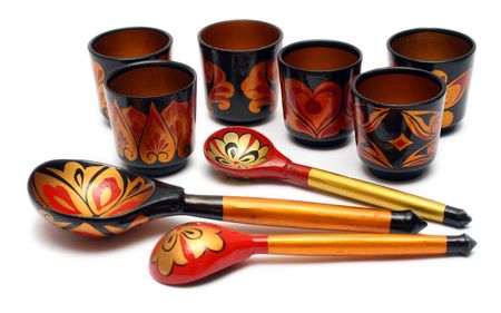 set of russian wooden spoons and cups isolated on white