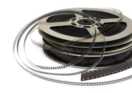 stack of old movie films on metal reel on whiteの写真素材