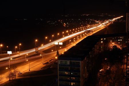 night road through bridge with street lamps