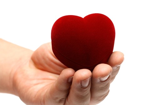 man's hand gidting heart on valentine day isolated on whiteの写真素材