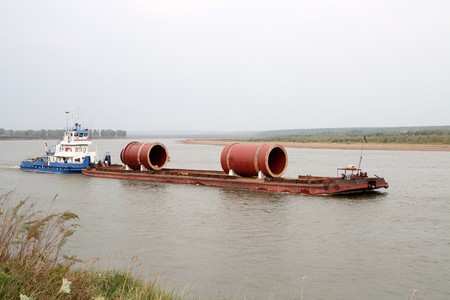industrial cargo transportation on river by ship with bargeの写真素材