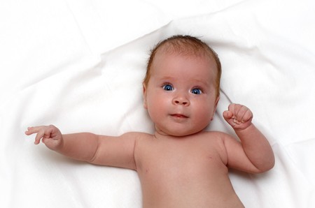 newborn femaly baby on white sheetの写真素材