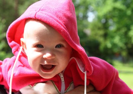 happy laughing baby outdoors under sunの写真素材
