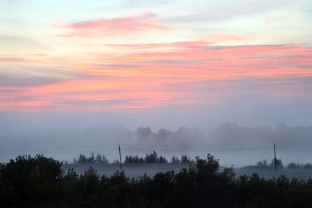 rural mist landscape with sunrise over lakeの写真素材