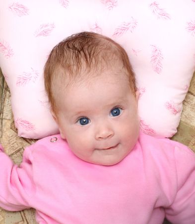 lying looking newborn baby girl portraitの写真素材
