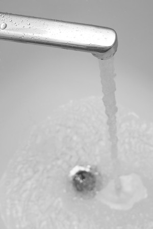 tap with strong stream of water in bathtubの写真素材