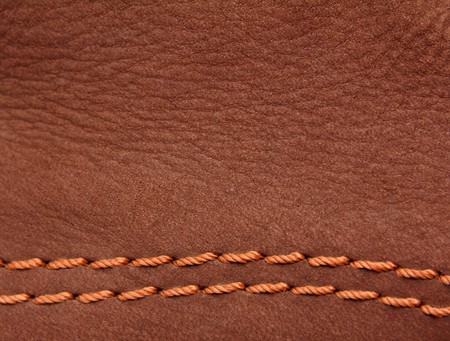 brown leather suede with sewn seams backgroundの写真素材