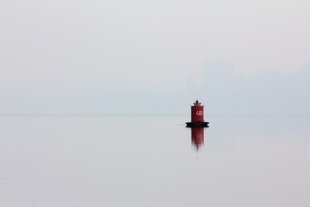red buoy on the river at mist morningの写真素材
