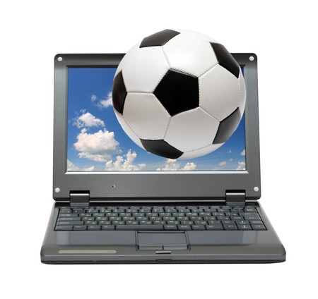 small laptop with soccer football ball out of screenの写真素材