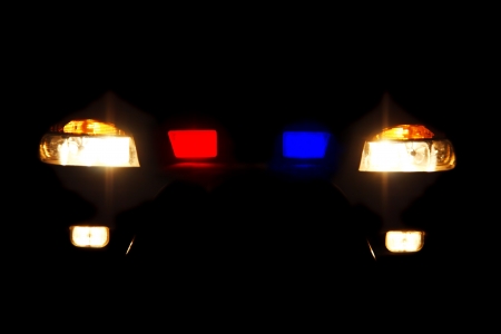 bright headlights of police car at nightの写真素材