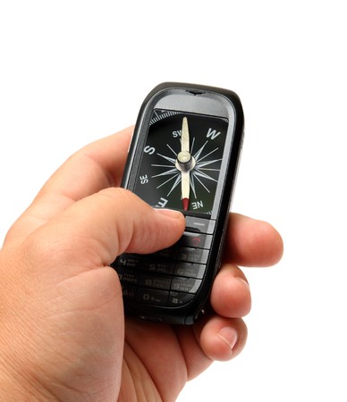 mobile phone in man hand with compass on screenの写真素材