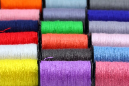 lot of colored thread spools - background