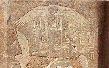 ancient egypt images and hieroglyphics on granite wall in karnak templeの写真素材