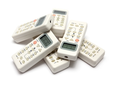 remote infrared devices in heap isolated on whiteの写真素材