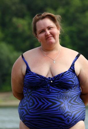 portarit of plump woman standing near riverの写真素材
