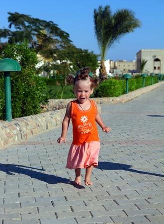 outdoor shot of happy little girl runningの写真素材
