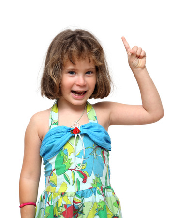 cheerful cute little girl pointing with finger upの写真素材