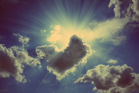 sun rays on dramatic sky wth clouds - vintage retro styleの写真素材