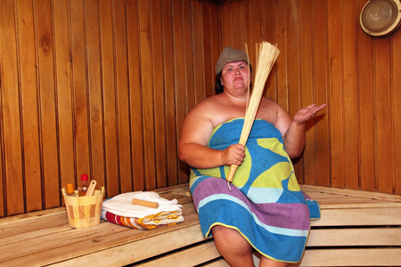 fun big overweight woman in saunaの写真素材