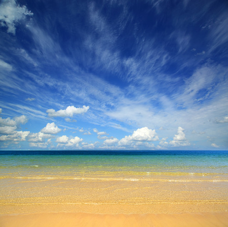 beautiful landscape with gold sand beach and cloudsの写真素材