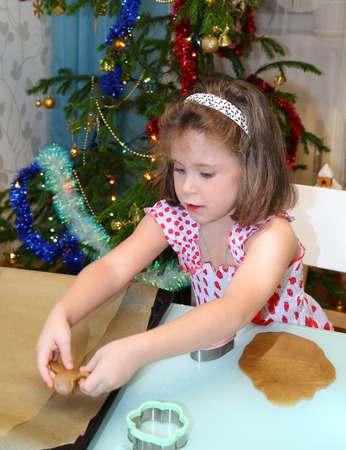 Little girl baking Christmas cookies at homeの写真素材