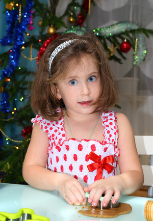 Little girl baking Christmas cookies at homeの写真素材