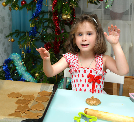 Little girl baking Christmas cookies at homeの写真素材