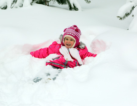 Winter fun - happy little girl in snowの写真素材