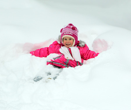 Winter fun - happy little girl in snowの写真素材