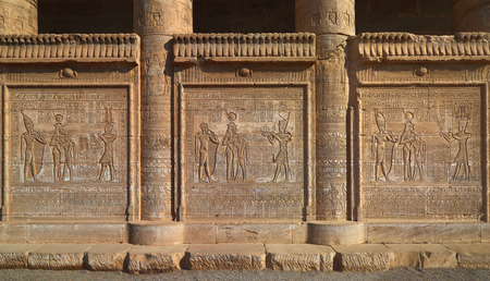 Hieroglyphic carvings on the exterior walls of an ancient egyptian temple