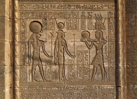 Hieroglyphic carvings on the exterior walls of an ancient egyptian templeの写真素材