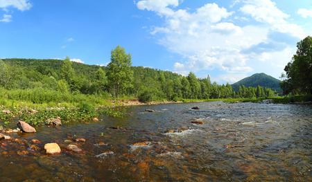 landscape with mountain river flowing over rocks at summerの写真素材