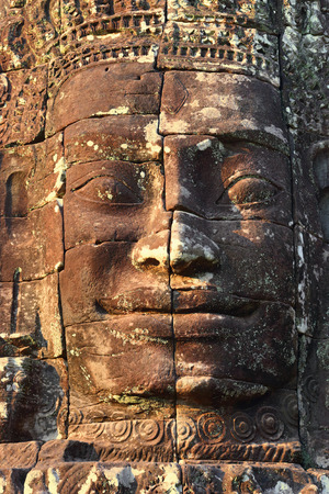 Giant stone face at Bayon Temple at sunset, Angkor Wat, Cambodiaの写真素材