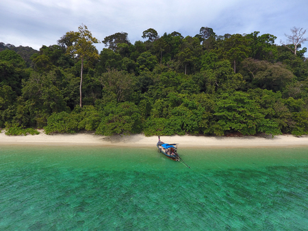 Aerial view on longtail boat and empty tropical beach in Thailandの写真素材