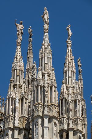 Marble statues - architecture on top of roof Duomo gothic cathedral in Milan, Italyの写真素材