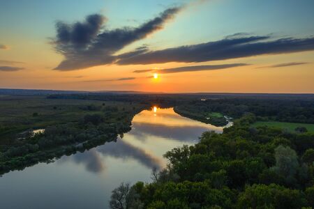 Aerial view landscape of sunrise or sunset with forest and riverの写真素材