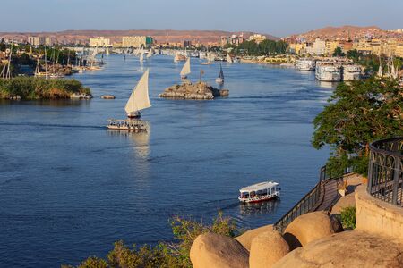 Beautiful landscape with felucca boats on Nile river in Aswan at sunset, Egyptの写真素材