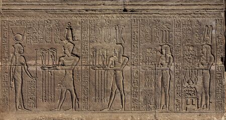Hieroglyphic carvings on the wall of an ancient egyptian templeの写真素材