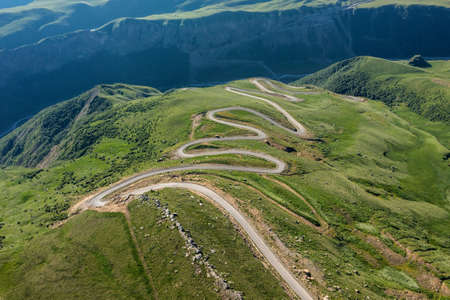 Winding road passing through mountainの写真素材