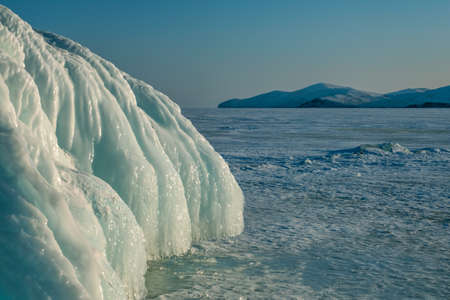 Ice and icicles on rocks on Lake Baikalの写真素材
