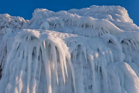 Ice and icicles on rocks on Lake Baikalの写真素材