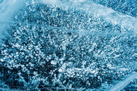 Blue ice and frozen bubbles on Baikalの写真素材