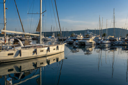 View of Harbor and marina with moored yachts and motorboats at sunsetの写真素材