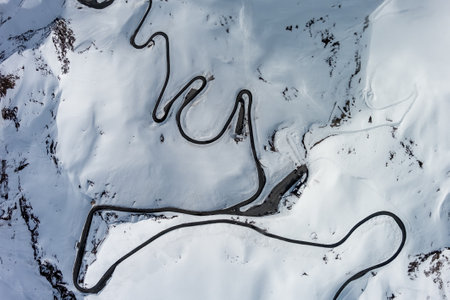 Aerial top view of Grossgloknershtrasse in snow. Great high mountain road near Grossglokner mount in...