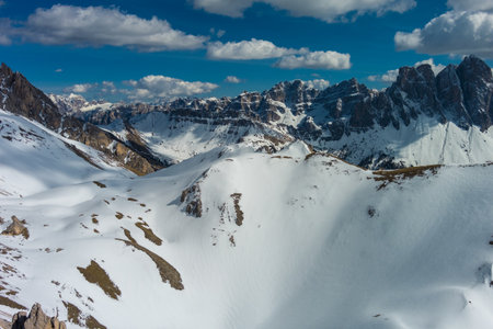 Aerial view of amazing rocky mountains in snow at sunset, Dolomites, Italy