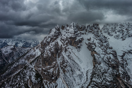 Aerial view of rocky mountains and cloudy sky in Dolomites, Italyの写真素材