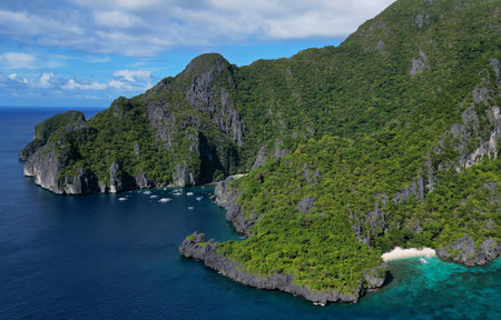 Aerial view of tropical Philippines island. White sand beach, rocks cliffs mountains with blue bay...